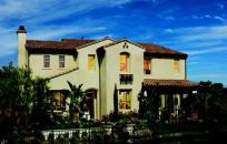 FAMILY-FRIENDLY: The Spanish elevation of the bestselling Plan 2 has everything that families  want, including five bedrooms and a loft, three and a half baths, a two-car  garage plus tandem storage space, and a dramatic vaulted ceiling in the  family room that adds flair to a well-used space.