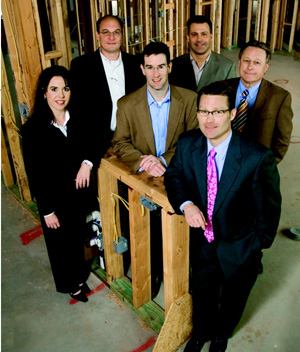 Front row: Vernon McKown, president of sales; Middle row, l to r: JaRee Stambeck, CFO; Russ  Gammill, vice president of purchasing; Gene McKown, president  of development; Back row, l to r: Todd Booze, president of construction; Brian  Rice, vice president of operations