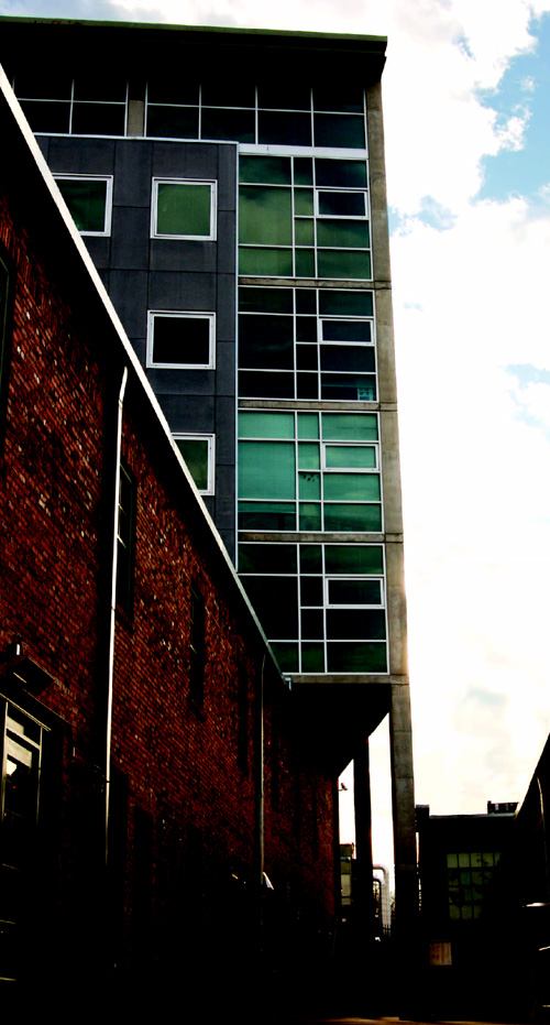 URBAN RENEWAL: Architect Manueal Zeitlin added 32 loft apartments by designing a building that fits over and through and old brick warehouse. A two-story live/work apartment (below) is just one of six plans available at Mercury View Lofts.