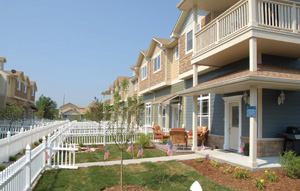 SENSE OF COMMUNITY: With a primary market of young military families, The Village at Freedom Place  was designed to foster close relationships among the residents, who often  face long separations from their deployed loved ones. Garages are alley-loaded. Fenced  front yards face each other along a “green sidewalk” to  make it easy for families to interact.