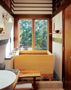 High ceilings and white walls contrast with the warm woods and give a feeling of airiness to the small space.