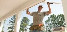 HOME STRETCH. Bill Tamony of Owens Brothers Construction attaches siding to the future house of the White family, sponsored by Dunn/Whitney Construction in Suffolk, Va.