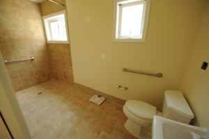 Open Access: The Andrus House, an AARP prototype home in Washington, DC, features a no-threshold shower, roll-under stove top, and lowered counter heights (2 inches below standard), plus appliances, light switches, and toe-kick pull-out cabinets, all set within reach of a person seated in a wheelchair. The kitchen also includes task lighting and a talking microwave for users with low vision.