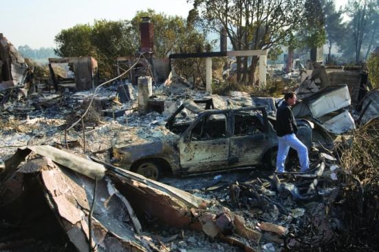 Too hot to handle: Homeowner Jay Gray surveys the destruction to his Rancho Bernardo, Calif., home after fires swept through his neighborhood in October 2007. Few local production builders have had much success participating in the rebuilding efforts.