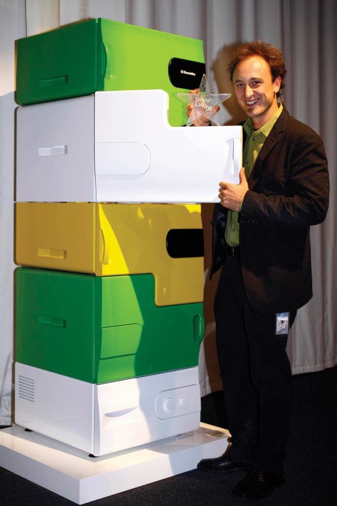 Electrolux Design Lab 2008 winner Stefan Buchberger displays the Flatshare refrigerator, which has separate drawers for each user. Individual users can personalize their drawer with a colorful "skin."