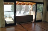 The bed rolls out onto a sheltered, screened porch so the owners can “camp out” even on buggy or stormy nights.