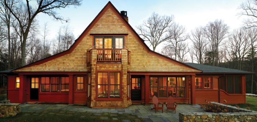 Pretty Face: The lake side of this upstate New York house paints a charming picture for boaters. A strong horizontal band of windows and doors is capped by a dramatic roof gable with wing extensions. “That peak is the toothpick through the club sandwich,” says architect Donald Powers.