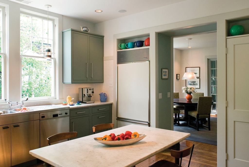 Stainless steel—in the form of a sink sectional and sleek cabinet hardware—brings a contemporary touch to the classic space.