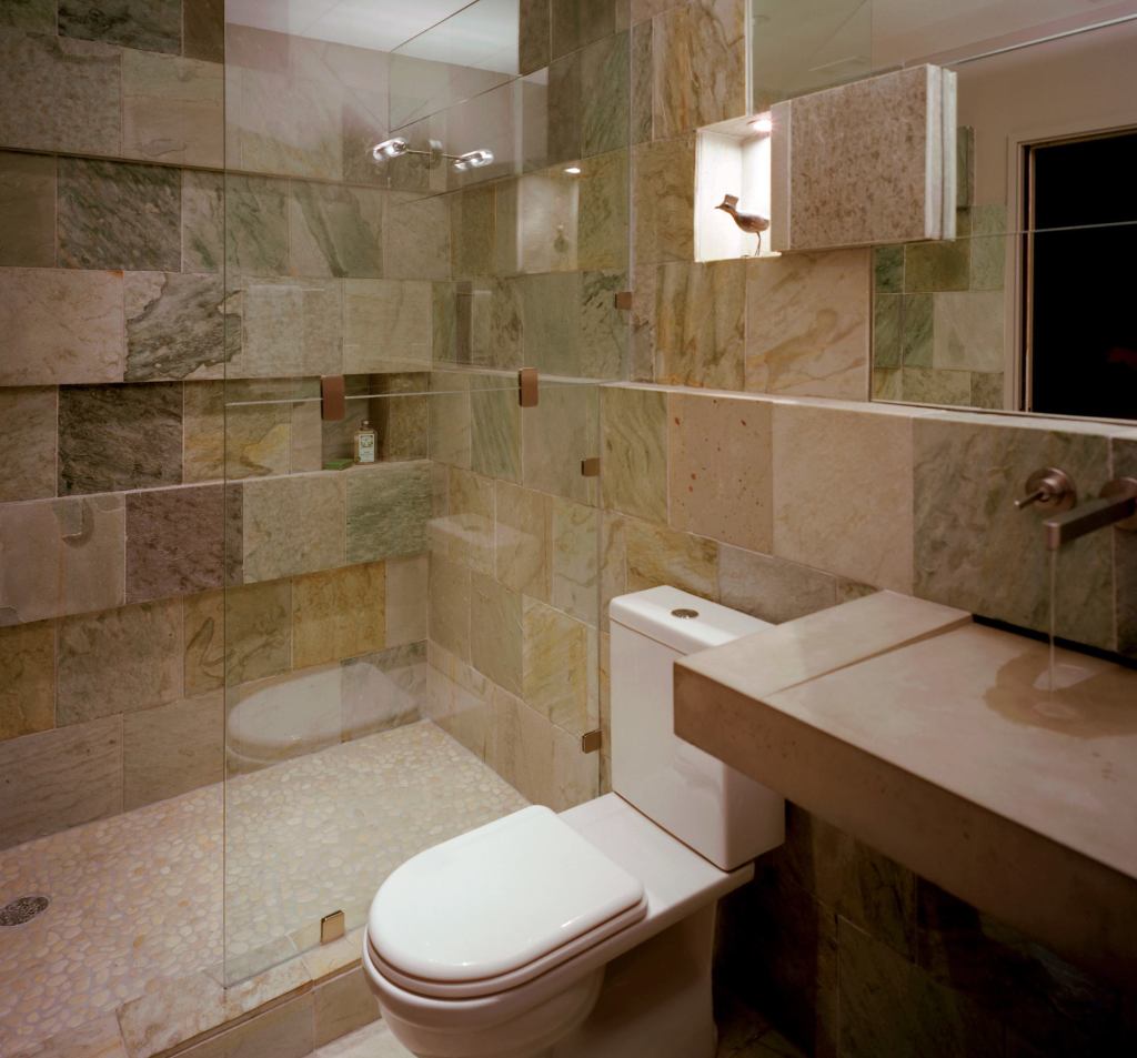 Designer Mark Lind made a wood mock-up of the floating sink to ensure water properly drained into its concealed slot. He took extra pains with the glass shower enclosure as well, so the tile ledge could run through it.