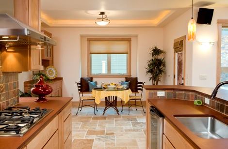 Knotty alder cabinetry in the kitchen is constructed with a zero-VOC composite particleboard interior and treated with a zero-VOC finish. Kitchen countertops are PaperStone, manufactured from 50 percent recycled newsprint.