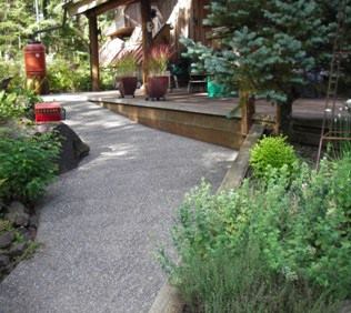 Instead of using strictly utilitarian ramps to provide access to wheelchair users, Stewardship Remodeling's Mike Vowels creates "stepless grade changes" that, when possible, travel through gardens or other outdoor features before arriving at the entryway. These access paths, here shown paved with an exposed aggregate, are part of his invisble approach to universal design, and they also do double duty as attractive landscaping.