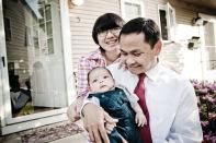 FINALLY ARRIVED: Cambodian-American Tooch Van, wife Chorvy, and son Winston, outside the Lowell, Mass., home they bought with help from a local housing group.