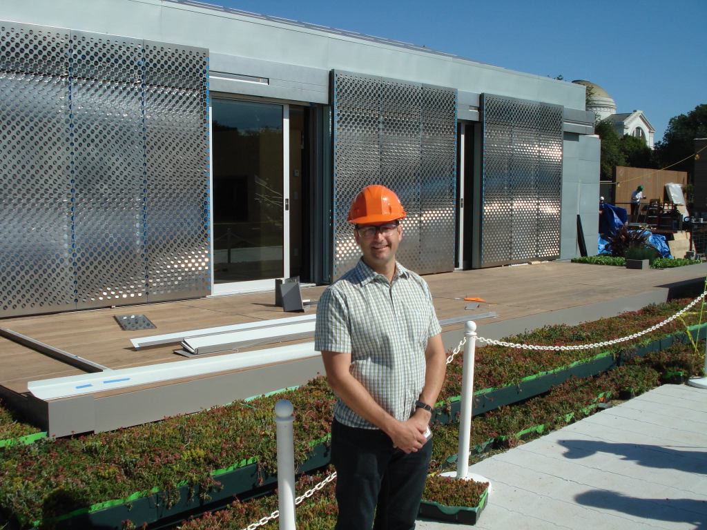 Andrew McCoy, associate professor at Virginia Tech, stands in front of the school's entry into the 2009 Solar Decathlon. The 800-square-foot home lives large thanks to sliding glass walls that open up the space.
