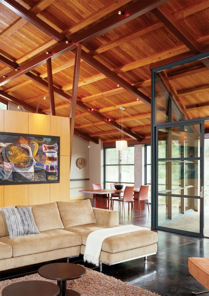 Open to the adjacent dining area, the room is separated from the living area by only a bank of storage cabinets.