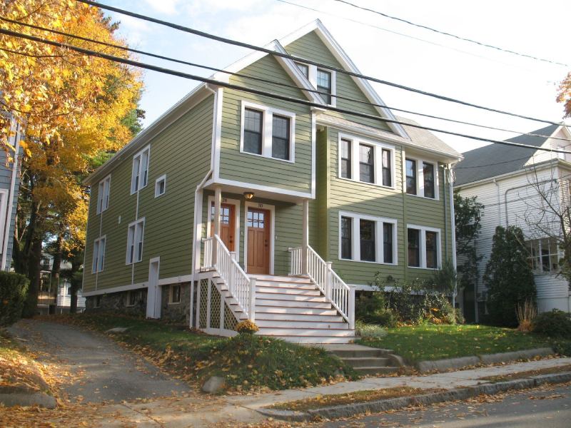 The Arlington, Mass., duplex strikes a pose with new siding, windows, and doors, but underneath the building's new foam insulation, exterior foam board, heat recovery ventilator,&nbsp;and&nbsp;tankless water&nbsp;heater help save the homeowners up to 68% in fuel oil cost per year.&nbsp;