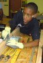 The young participants learn the basics of electrical wiring, plumbing, carpentry, and more from builders and contractors who visit each week.