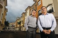 Frank Mackle (far right) and Venny Torre of Torre Mackle Group, standing in front of Terzetto Villas, a townhouse project in Miami they built out for Ocean Bank, which provided construction financing.