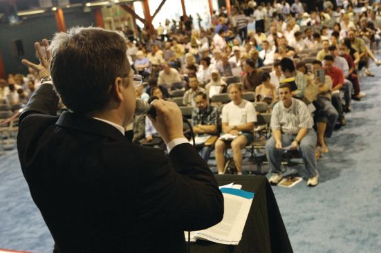 ON THE BLOCK: An auctioneer conducts an event in Los Angeles for REDC, which last year held 232 auctions in ballrooms and online.
