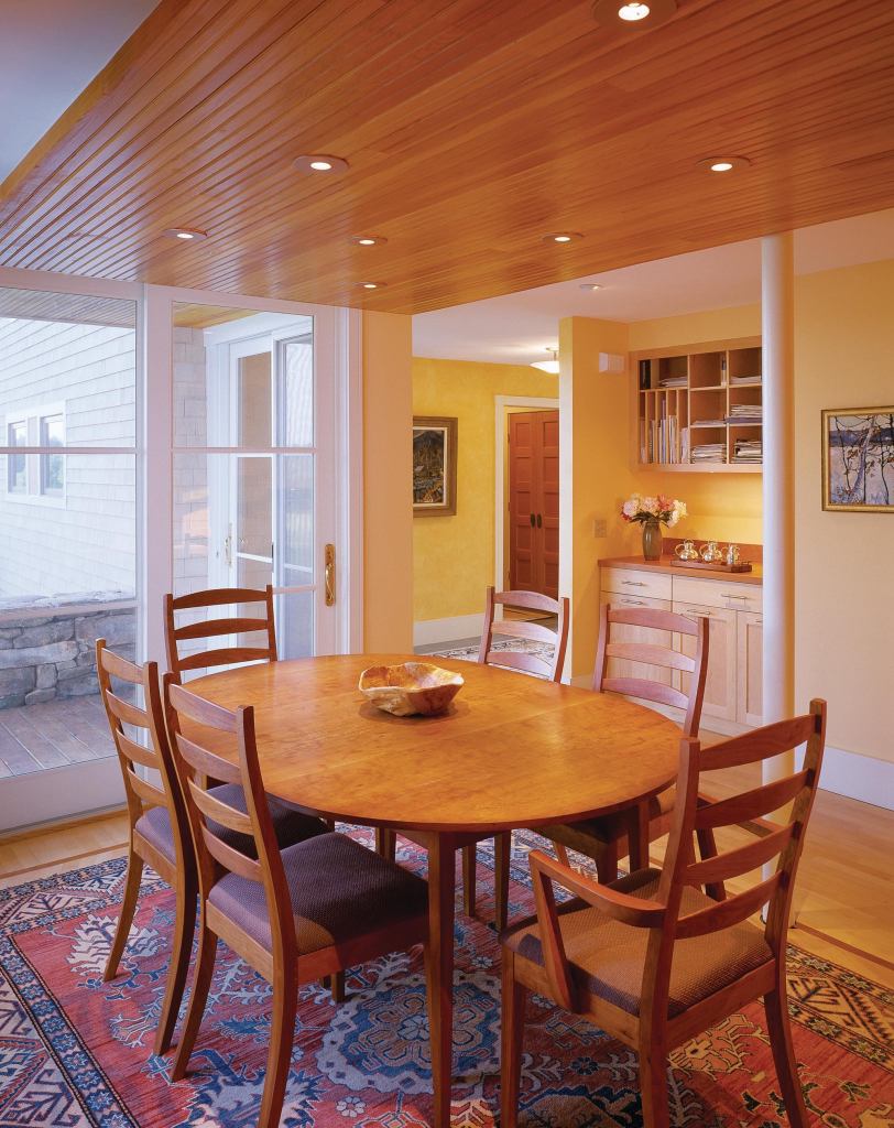 The beaded fir paneling serves as an aesthetic bridge from the early 19th-century building to its contemporary addition. With a clear finish, the paneling also serves as a visual link with the exposed, rough-sawn beams of the earlier 1980s-style living area.