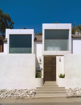 Street Cred

Besides creating a new identity for the front of this home in an urban neighborhood overlooking Hollywood, the cantilevered room-size window boxes shade and protect the interior courtyard and contain lights and speakers for outdoor entertaining.