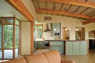 The island supplies both separation from and connection to the living and dining areas, creating an equilibrium within the space.