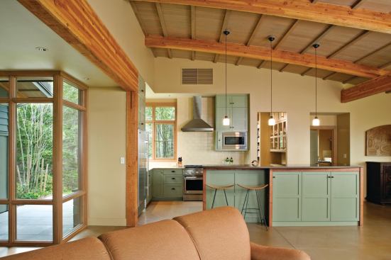 The island supplies both separation from and connection to the living and dining areas, creating an equilibrium within the space.