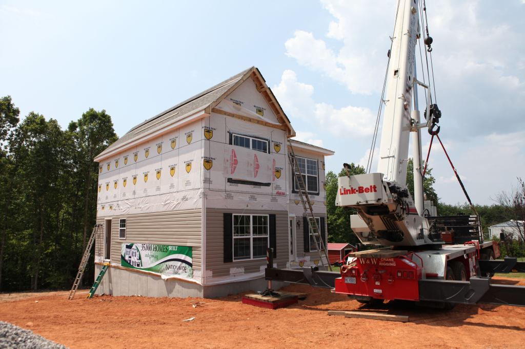 Landmark Setting Cranes place the modules on a jobsite in Axton, Va., for the 35,000th house that modular manufacturer Nationwide Homes has produced in its 52 years.