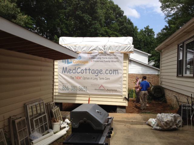 After being craned over the roof of the existing home at right, this medical ADU was fastened to a prepared pier foundation. The two units will later be connected by a deck.