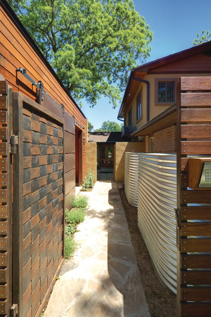 Two corrugated steel cisterns are hidden from street view along one of the home's entryways. Each cistern stores 1,000 gallons of rainwater that is used to tend landscaping and a vegetable garden.