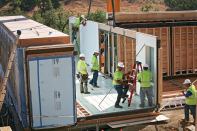 Labor Dispute. Workers assemble a home made from modules produced by Blu Homes, the California-based manufacturer that has run afoul of Carpenters Union Local 180, which accused the company of unfair labor practices.