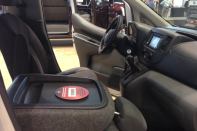 Taken at the 2013 Remodeling Show, an interior shot of the 2014 Nissan NV3500 shows how the fold-flat front passenger's seat can serve as a work table.