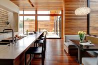 Mahogany siding wraps around the house and continues to the interior, reinforcing an inside-outside connection.