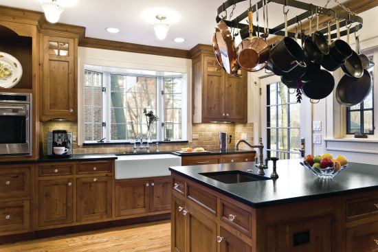 Room for Two: Alder cabinets, honed granite countertops, and a tumbled marble backsplash give this kitchen a rustic feel.