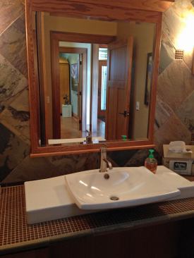 Vanity Fair: No Tilted Mirrors Another example of a lowered counter height is in the front hall bathroom. In addition to providing accessibility, Mark says the 32-inch vanity height let them bring the bottom of the mirror lower as well. The result is a lovely design that avoids awkward (and often institutional) titled mirrors.