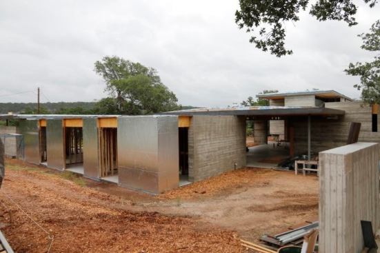 We use mulch against the board-form walls to ensure mud isn’t splashed on the concrete. We’ve found those stains are tough to remove later. Better to prevent them to begin with.


No overhangs on this elevation so we used a more “bullet proof” weather-resistive barrier WRB. This is a 40 Mil peel & stick product from Polyguard