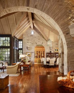 In this lodge-style house in Austin, Texas by Paul Lamb Architects and Don Crowell Builders, a stone wall helps differentiate the great room from the kitchen, while a dramatic archway helps unify the two spaces.