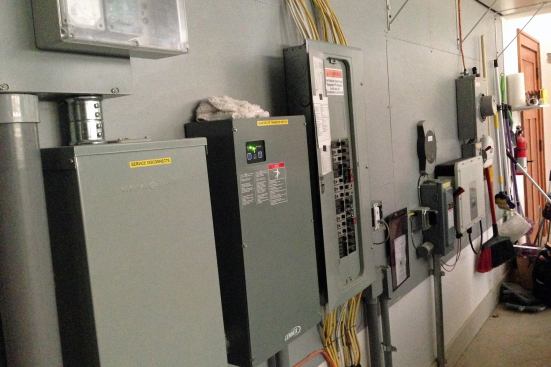 Power Play: Electrical Panels in the Garage Electrical panels are often installed in the basement or some out-of-the-way corner, but homeowners that can't make it up and down stairs may not be able to access them if a breaker trips or the power goes out. In the UDLL, Mark solved this problem by moving the panels to the garage and installing them at a wheelchair-accessible height. The garage has a no-threshold transition so Rosemarie can move through it easily and check the panels if necessary.