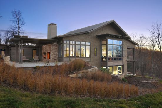 A double-decker covered porch flanks the other side of the house providing outdoor spaces with a variety of views and experiences.