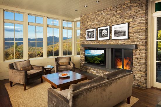 The protected patio sits to the side fo the living room, which shares the stone wall and the fireplace.