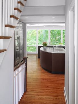 The front entry allows sightlines clear to the back of the house, with the main kitchen island steps away from the front door.
