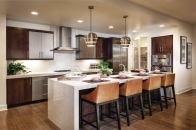 Hub of the House KTGY's work on KB Home's Skylar at Playa Vista in Los Angeles features "super kitchens" that cater to entertaining, dining, and conversation.