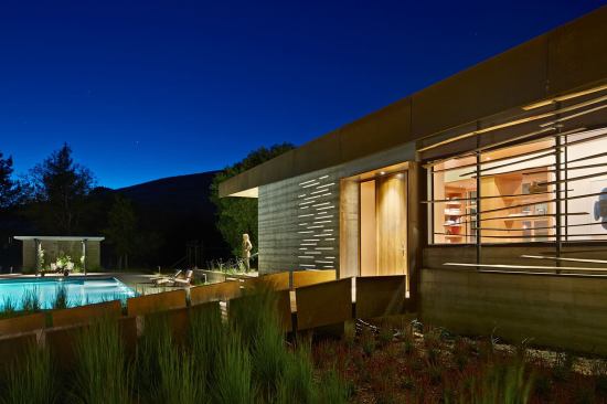 Acrylic strips embedded in the concrete wall glow with light from the interior.
