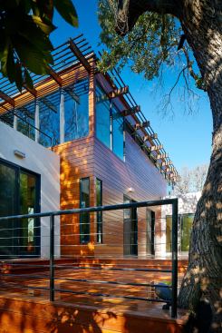 Wood was reused when possible, and new rooms were stepped down the sloped site to preserve heritage oaks.