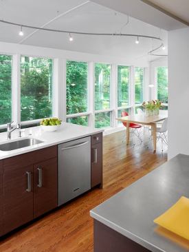 Perpendicular to the big island is a prep and cleanup island with a dishwasher, storage, and seating on the other side.