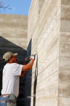 Removing the fiberglass wall ties. We cut them flush and they are so hard to see.