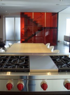 Once a run-of-the-mill spec house, this home now sports an authentic minimalist interior, complete with a monochromatic palette throughout most of the design. Providing contrast to the white walls, cabinets, and glass accents, a dramatic two-story red glass stair enclosure lends a sculptural focal point. Architect: Arch 11, Boulder, Colo. Builder: Ellsworth Builders/Hammerwell, Boulder