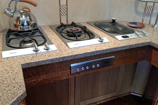 Cooking Confidence: Easy Access Burners ADA-compliant ranges put the cooktop controls at the front of the appliance so users can access them easily without reaching over hot surfaces. The UDLL takes things a step further by installing individual burners side by side in the cooking area, eliminating the problem of hard-to-reach back burners. In this configuration, Rosemarie can easily and safely reach each cooking element, as well as vent hood controls.