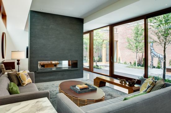 The 2013 Custom Home of the Year, by GGC Contracting and Vinci Hamp Architects, is a former dairy in Chicago that was remade into a family home. The living room’s fireplace is surfaced in Indian black granite.