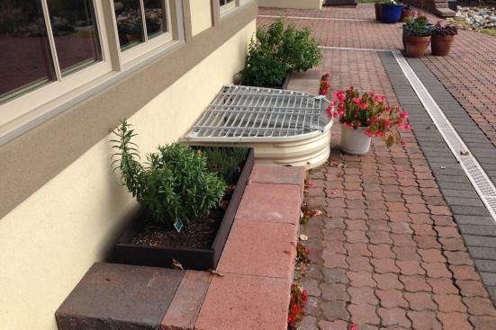 Outdoor Enjoyment: Planter Boxes Adjusting to life in a wheelchair made Rosemarie's love of gardening a challenge. Mark says chair-height planters bring the gardening to a convenient height for Rosemarie to roll up to and tend any time she likes. The landscaped back yard also incorporates paver ramps and pathways so the couple can enjoy all of its amenities together.