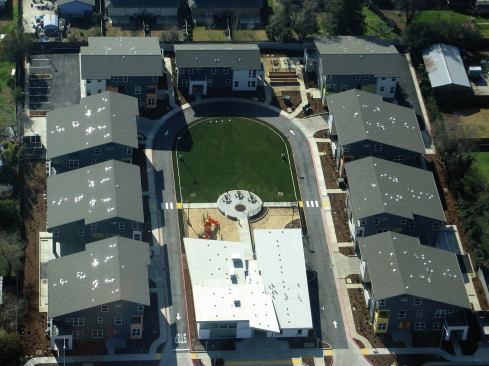 The affordable housing project consists of 2, 3, and 4-bedroom units with a central community building housing an early childhood daycare facility. 